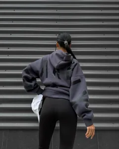 Detailed back view of a grey oversized women's hoodie with bold black 'MARLY' letter print.