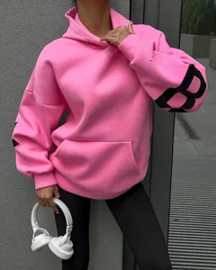 Trendy pink oversized hooded sweatshirt with large black B letter print on the sleeve