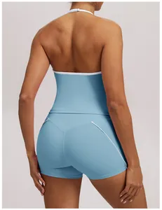 Close-up back view of light blue halter yoga tank and matching shorts with white piping