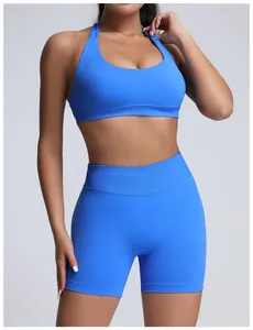 Detail view of a seamless high-waist blue yoga shorts and sports bra set on a fitness model.