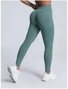 Rear view of seamless teal high-waist yoga leggings with peach butt lift design