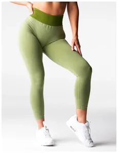 Close-up detail of high-waist green seamless yoga leggings on model with white sneakers