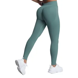 High-waisted seamless matte yoga leggings with peach hip lift effect in stylish teal green
