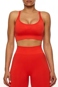Close-up of seamless red sports bra and high-waisted leggings with ribbed textures.