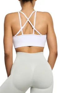 Back view detail of white criss-cross sports bra and high-waist seamless leggings