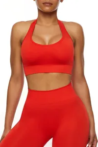 Close-up of red seamless halter sports bra and high waist yoga leggings set on model
