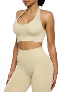 Detail of seamless high-waisted yoga set featuring halter neck sports bra in cream.
