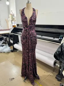 Detailed view of a purple leopard print halter maxi dress with a sexy deep V-neckline