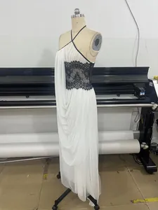 Sexy elegant white halter neck long dress with black lace waist detail on mannequin