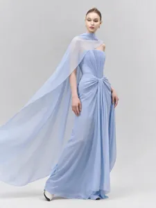 Full-length detail of elegant light blue strapless evening gown with sheer chiffon cape