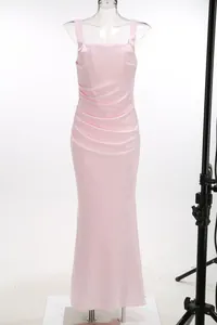 Full display of an elegant pink pleated satin sling long dress on a white mannequin.