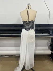 Back view detail of a black lace halter neck evening gown with white flowing chiffon skirt