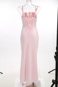 Rear detail view of elegant pink satin evening gown featuring lace-up corset back