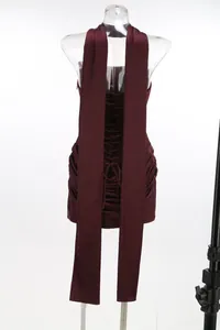 Back view detail of burgundy ruched bodycon mini dress with lace-up corset design