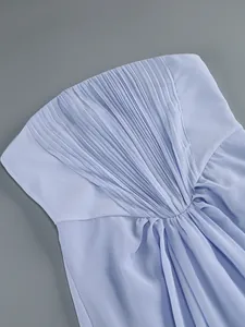 Exquisite close-up of elegant pleated detail on a light blue strapless evening maxi dress