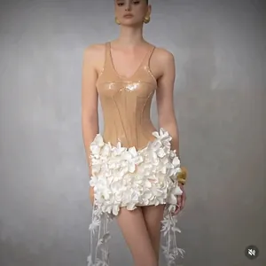 Detailed view of an elegant beige sequin bodysuit with a white 3D floral appliqué mini skirt
