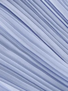 Macro detail of pleated light blue chiffon fabric texture for an elegant evening dress
