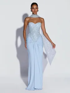 Full view of elegant light blue sequined strapless evening gown with draped detailing