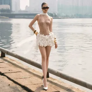 Detailed view of elegant champagne sequin corset dress with 3D white floral decorations