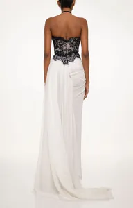 Detailed back view of a contrast black lace and white chiffon evening gown with train