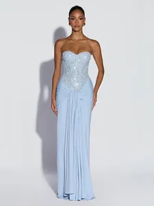 Elegant light blue sequined strapless maxi evening gown with draped detail on a model.