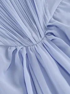Close-up detail shot of light blue pleated chiffon fabric texture on evening maxi dress