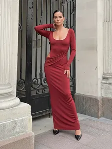 Elegant burgundy long-sleeved maxi dress with sexy side cutout and draped pleated details