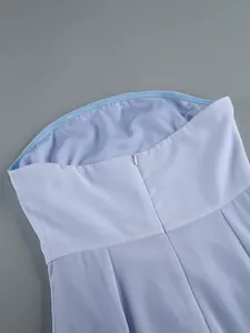 Close-up detail showing the invisible back zipper of a light blue strapless party gown
