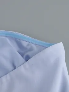 Close-up detail of the non-slip silicone strip on a light blue strapless maxi dress