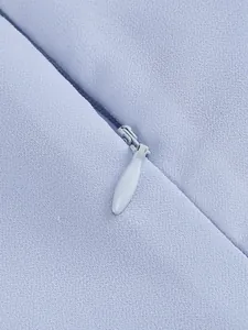 Detailed view showing the high-quality concealed zipper on light blue elegant dress