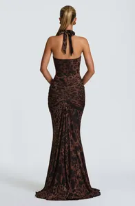 Back view of an elegant leopard print halter maxi dress with backless ruched detail.