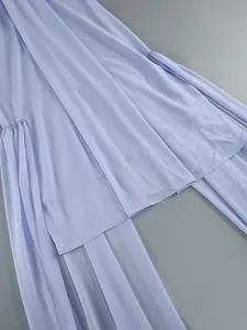 Close-up of light blue chiffon dress detailing with elegant draped fabric layers
