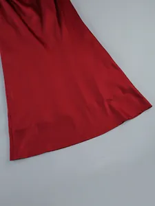 Detailed close-up view of a wine red satin formal long dress hem with smooth texture.