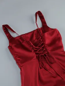 Exquisite detail of a sexy red satin evening dress featuring a lace-up corset-style back