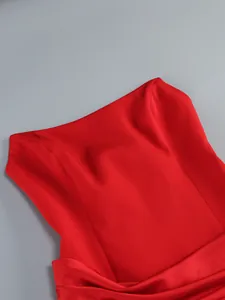 Detail of vibrant red off-the-shoulder formal dress showing smooth fabric texture