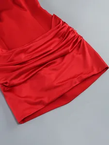 Close-up detail of a red satin ruched bodycon cocktail dress with elegant draping