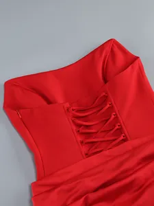Close-up detail of a vibrant red off-shoulder dress with elegant lace-up back design