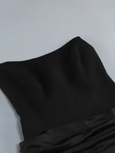 Close-up of a black off-the-shoulder evening dress with boning and satin drape
