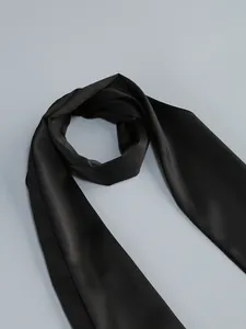 Detail shot of an elegant black satin sash for a formal evening dress accessory