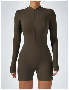 Detail of khaki long-sleeve athletic romper with front zipper for yoga and fitness.