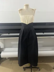 Detail of a black and white color-block maxi dress on a mannequin with floral straps