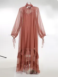 Detail of a sheer terracotta ruffled maxi dress with a pleated stand collar design