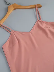 Detailed shot of an elegant pink camisole top featuring thin adjustable shoulder straps