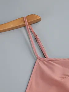 Close-up view of adjustable strap on a dusty pink camisole dress with fine stitching detail