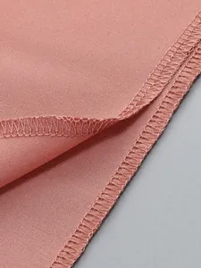 Close-up of overlock stitching on dusty pink fabric for a ruffled elegant dress