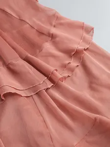 Detailed view of dusty rose layered ruffled chiffon dress showing fabric texture
