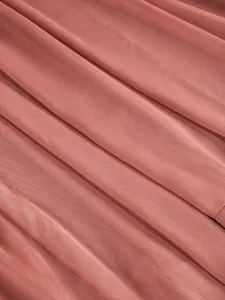 Close-up macro view showing the delicate pleated texture of the dusty rose sheer fabric.