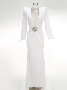 Elegant white deep V-neck long sleeve evening gown with crystal brooch detail