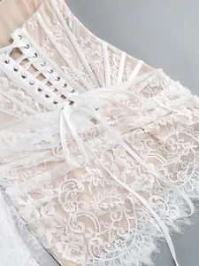 Close-up detail of exquisite white floral lace corset with elegant ribbon lace-up back