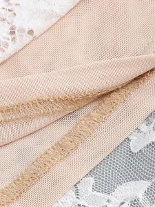 Close-up showing the professional overlock stitching on beige lace mesh dress fabric